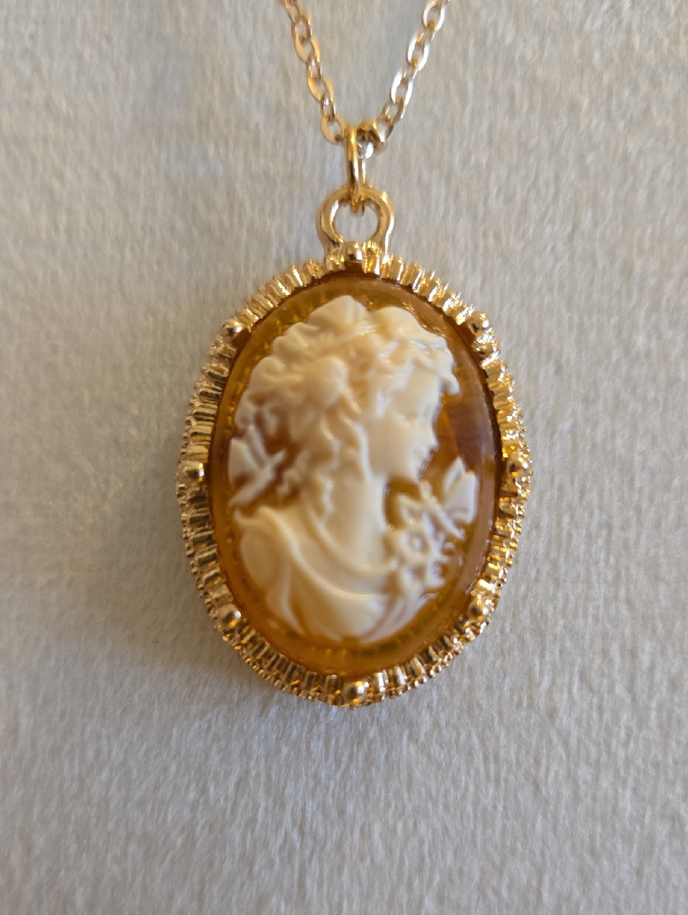 Gold Raised Cameo Pendant Necklace On Intricate Diamond Cut Chain Back in Stock.